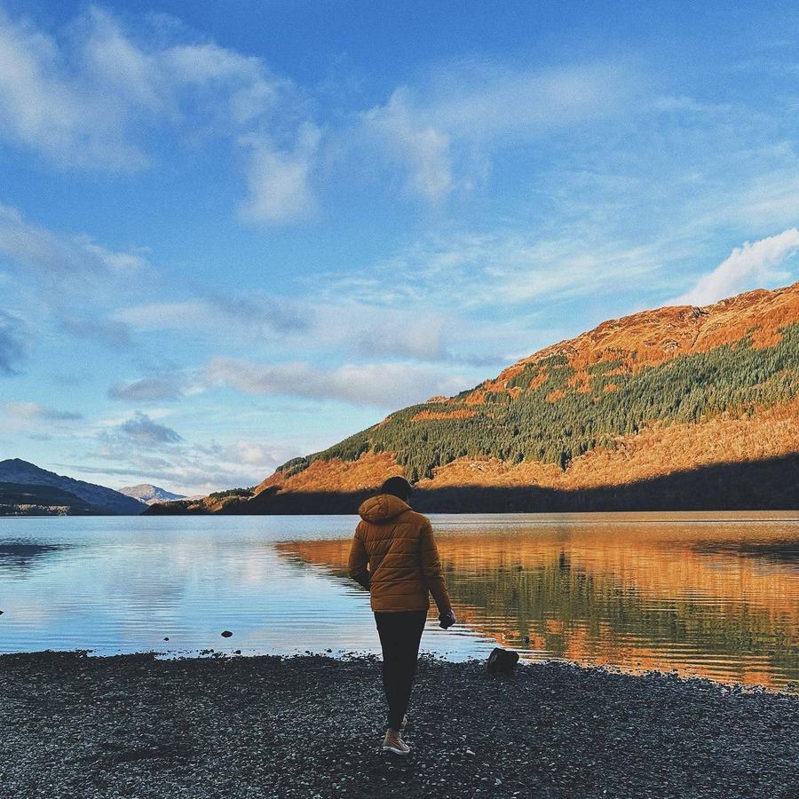 Callan walking the shore of a golden loch