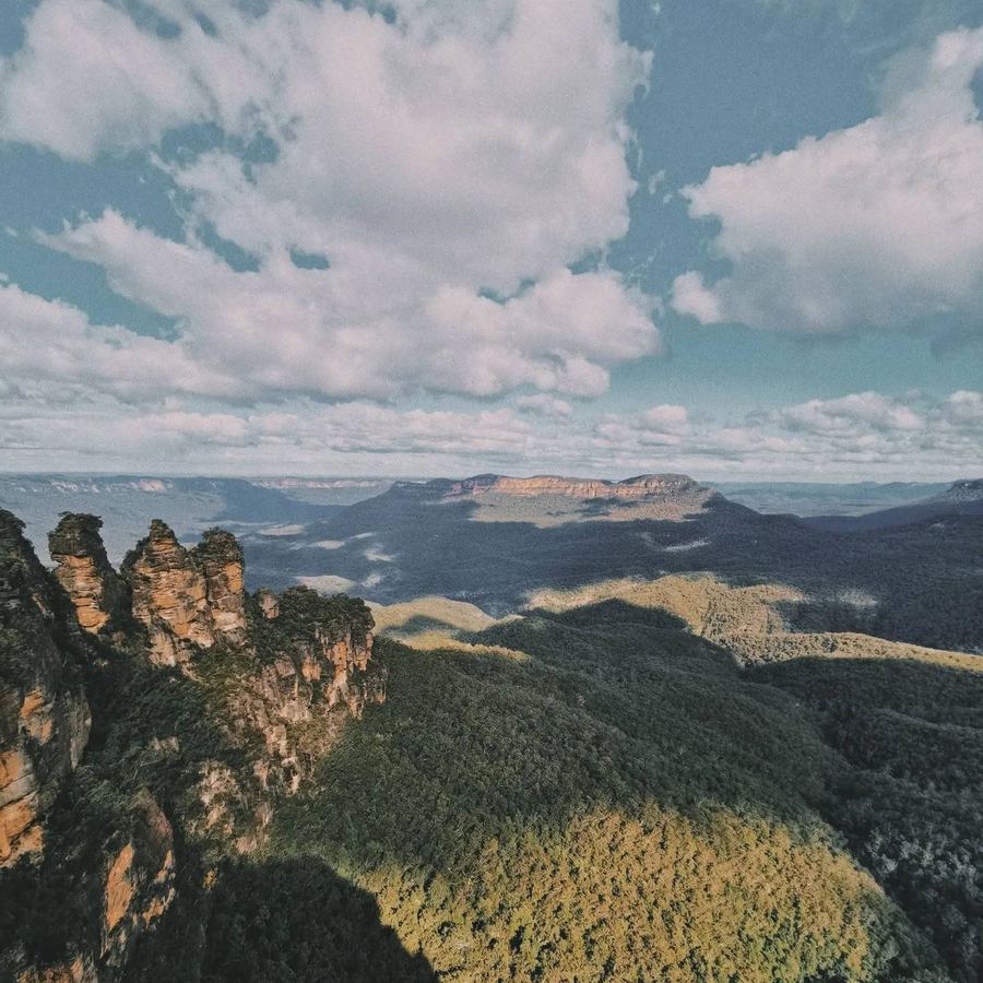 An aerial view of a mountain range under clouds